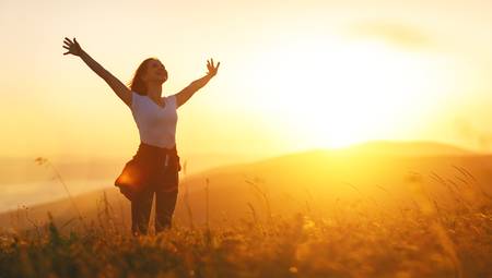 80903539-happy-woman-on-the-sunset-in-nature-in-summer-with-open-hands-.jpg